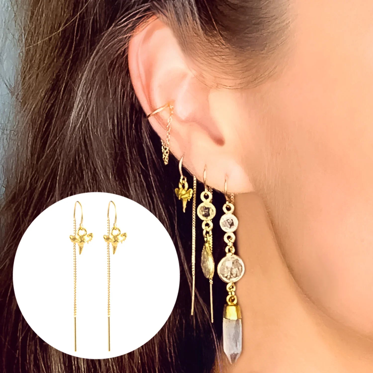 Close-up of a model wearing gold Genuine Shark Tooth Short and long Threader Earrings with additional gold earrings and ear cuffs- BeachBu Jewelry