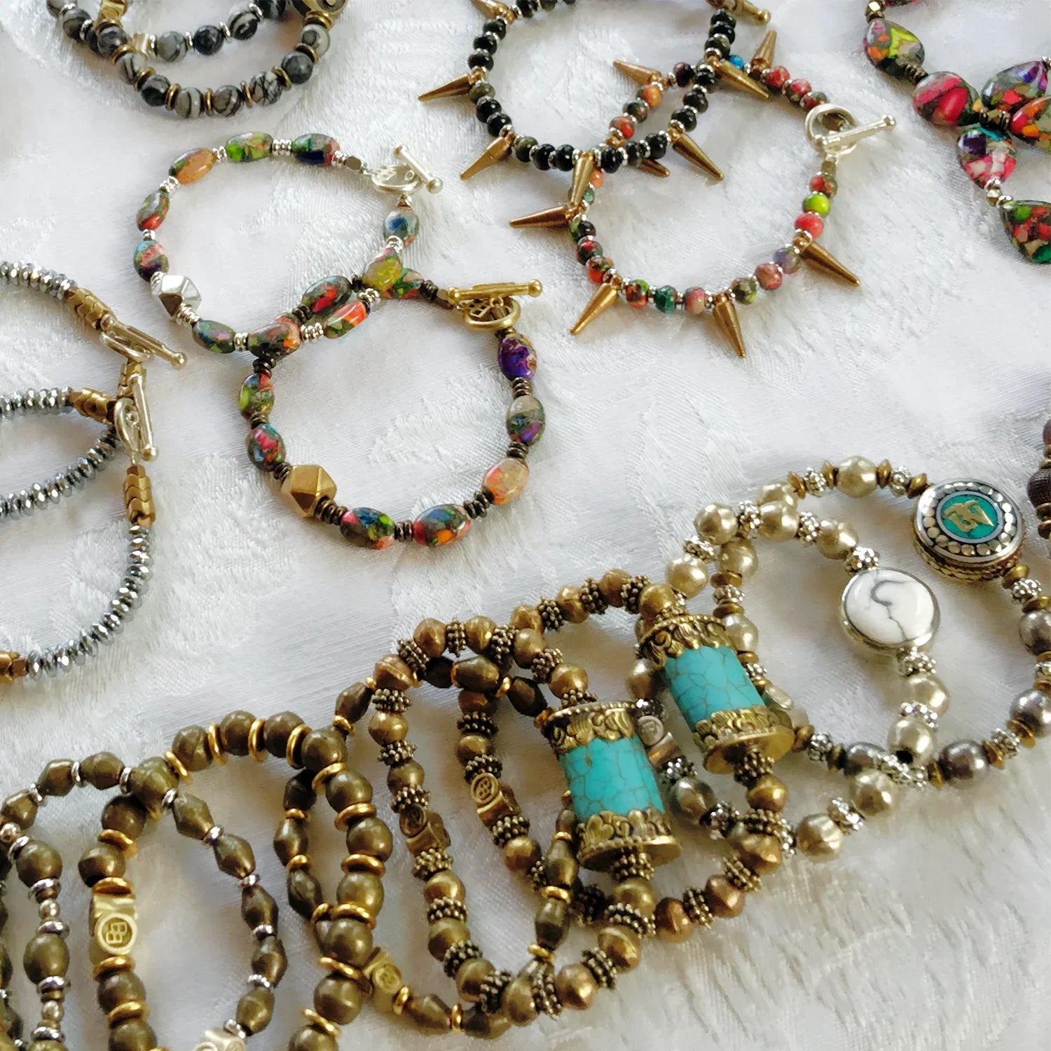 Collection of various beaded necklaces on a textured surface