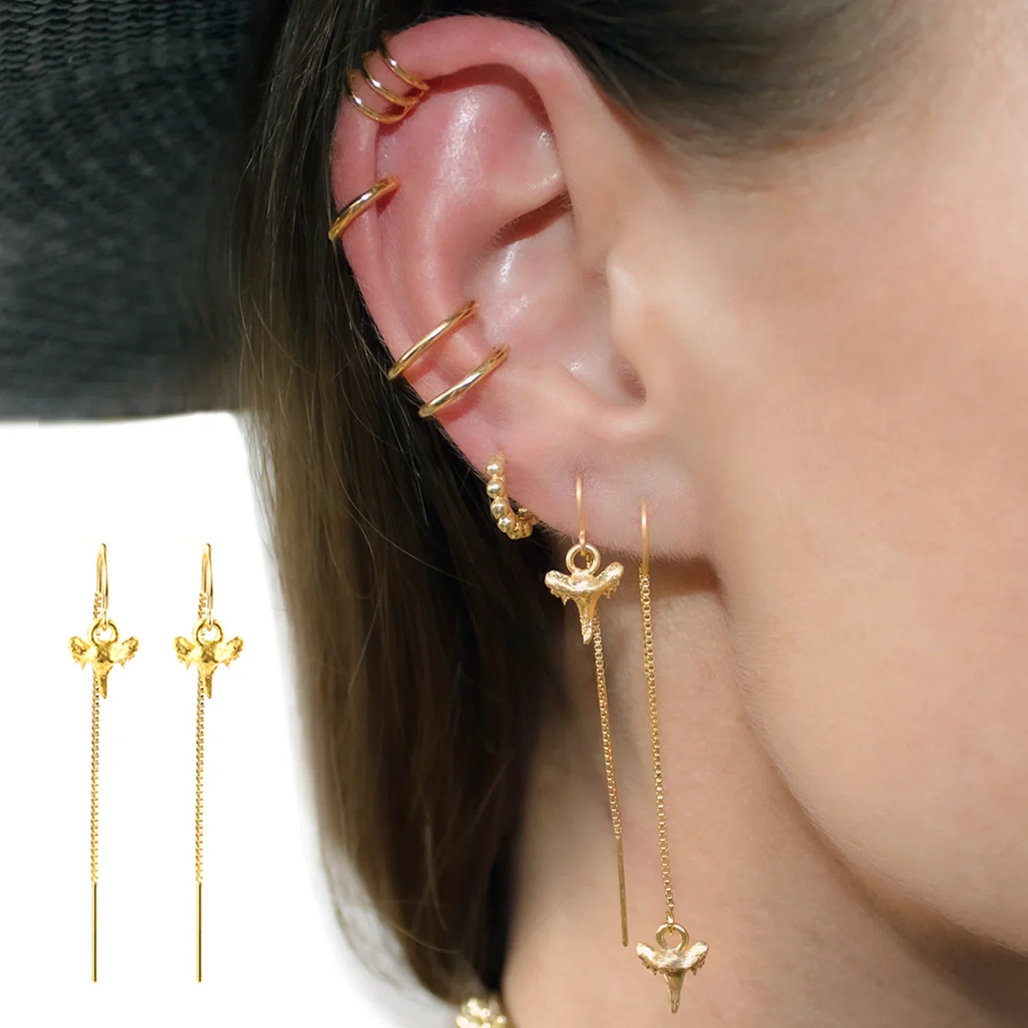 Close-up of a person wearing gold Genuine Shark Tooth Short and long Threader Earrings with additional ear cuffs and huggie hoops - BeachBu Jewelry