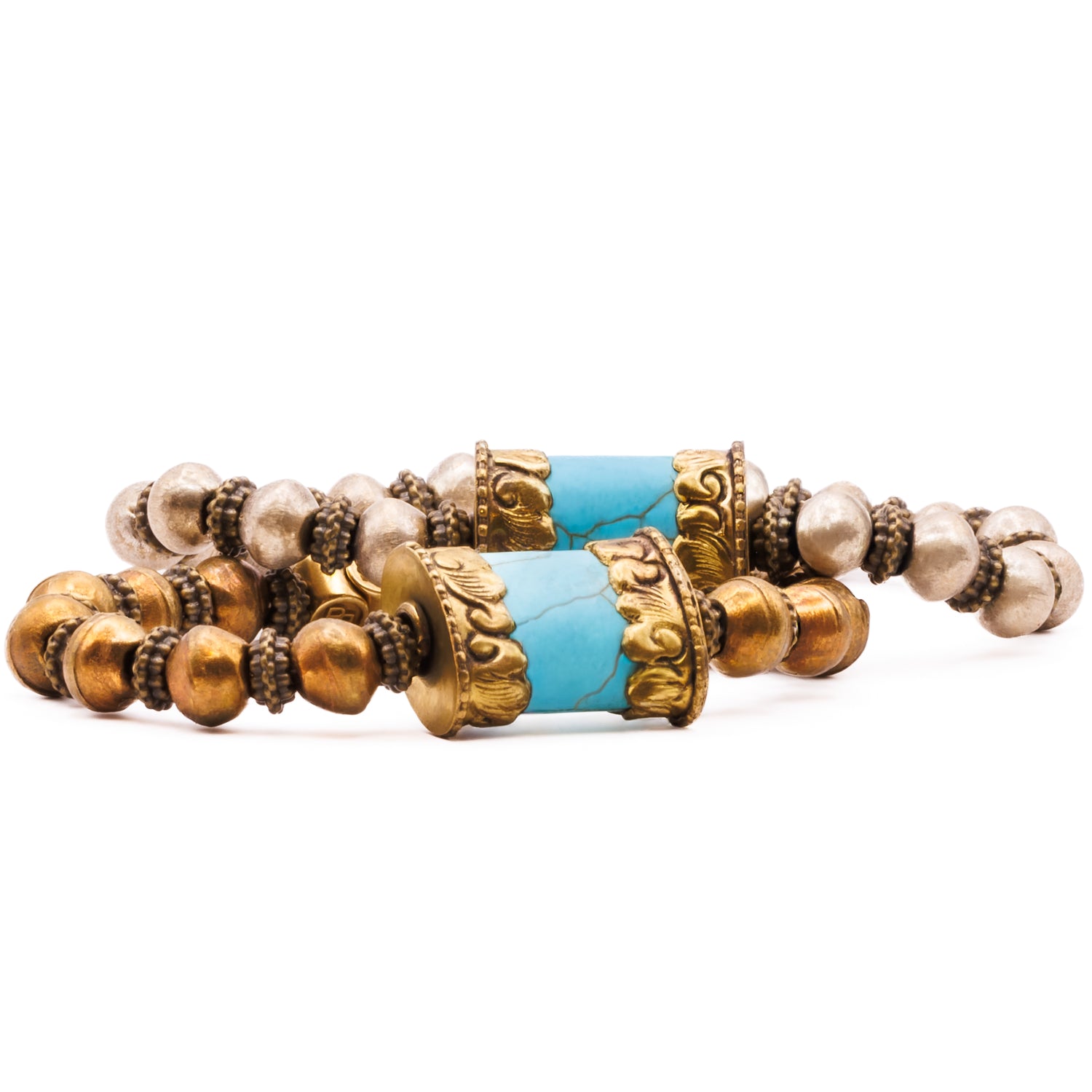 Bracelet with gold and bronze accents and turquoise stones on a white background